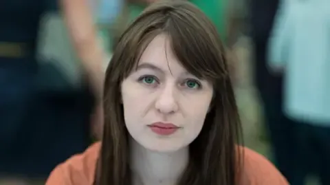 Sally Rooney states she will not travel to the UK over legal concerns
